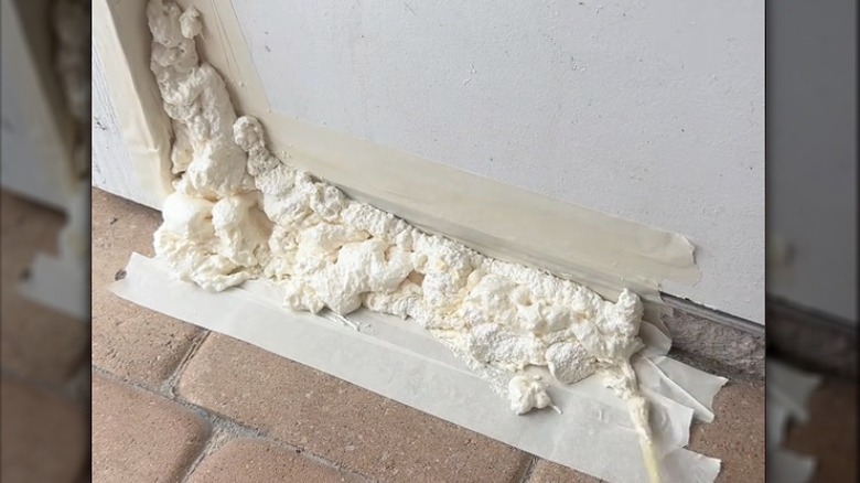 Using spray foam to stop water coming through a door