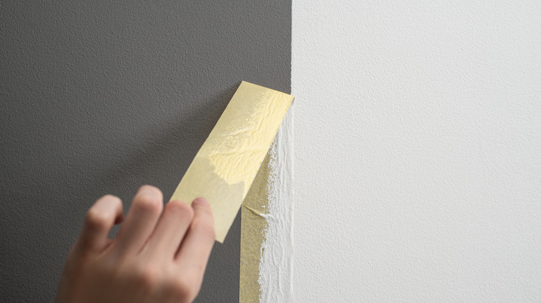 Peeling tape off of wall