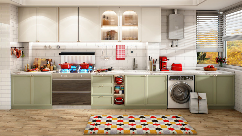 Kitchen with different appliances and a yellow, red, grey and white rug with patterns