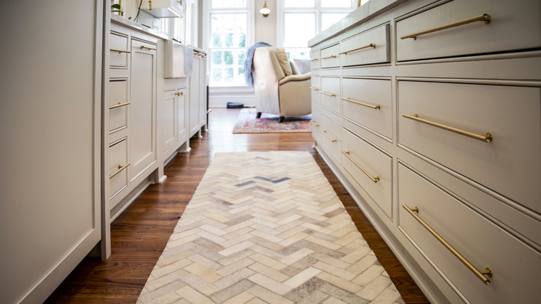 Light-colored runner on floor in kitchen with natural light