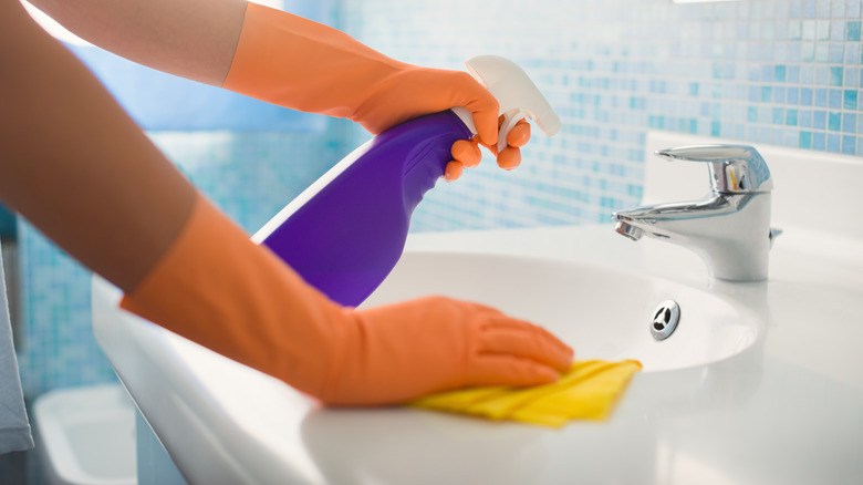 woman cleaning sink area