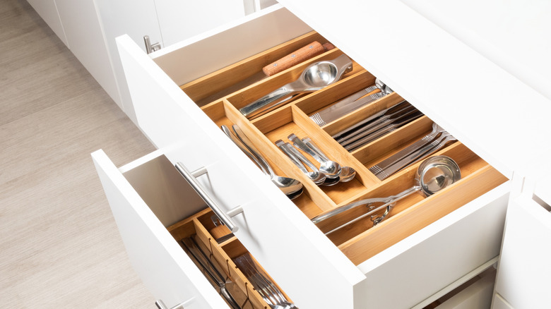 two open kitchen utensil drawers