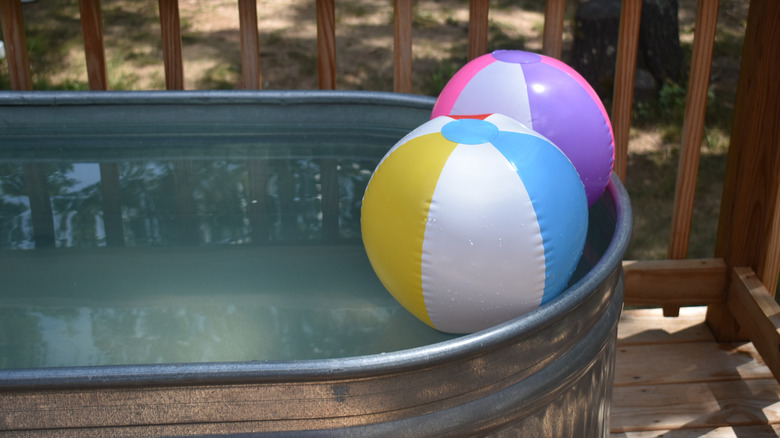 inflatable balls in stock tank swimming pool