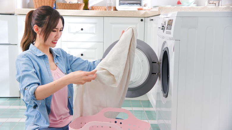 Woman looking at soiled clothing