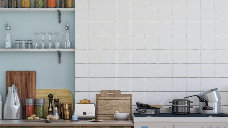 kitchen with blue wall and white square tiles