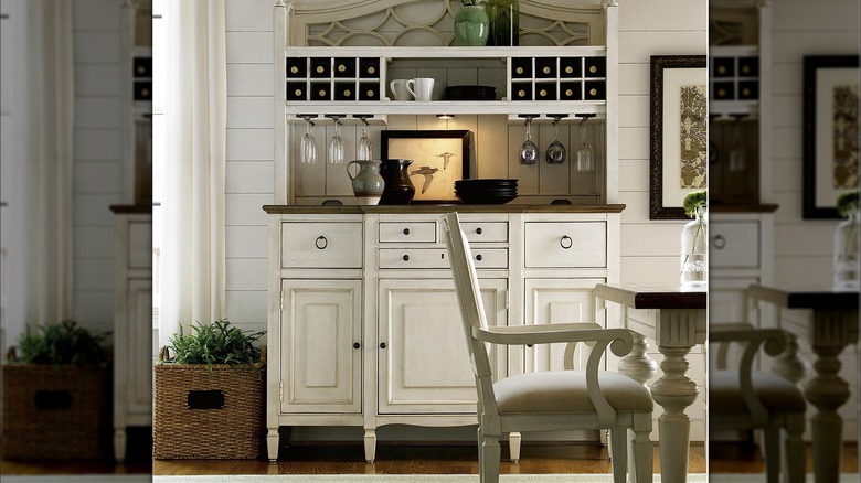 A creamy white kitchen buffet in a dining area