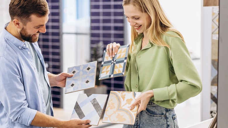 couple choosing tiles 