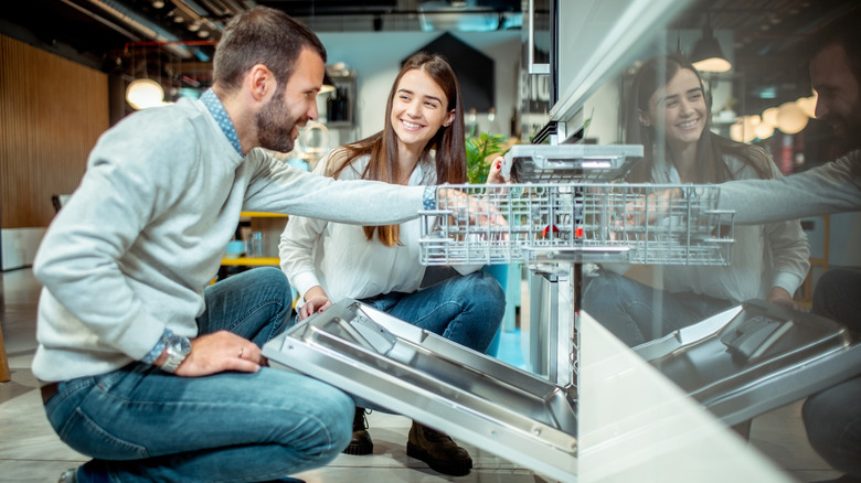 Young couple with new dishwasher