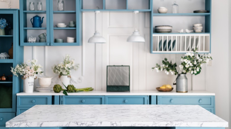 marble island and blue cabinetry