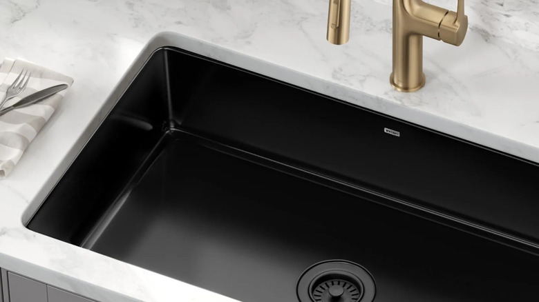 Black porcelain single bowl undermount sink installed in kitchen