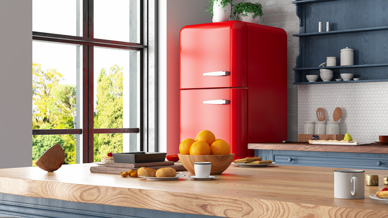 Red retro fridge in a blue kitchen