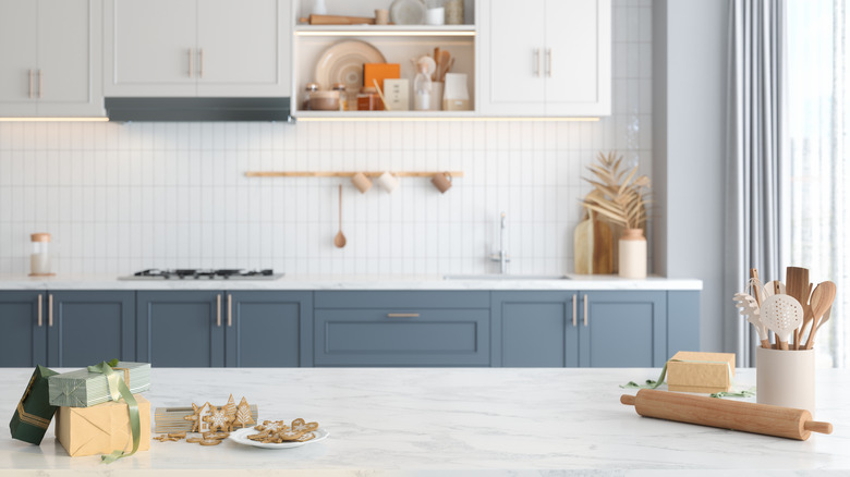 Contemporary blue and white kitchen with soft white countertops