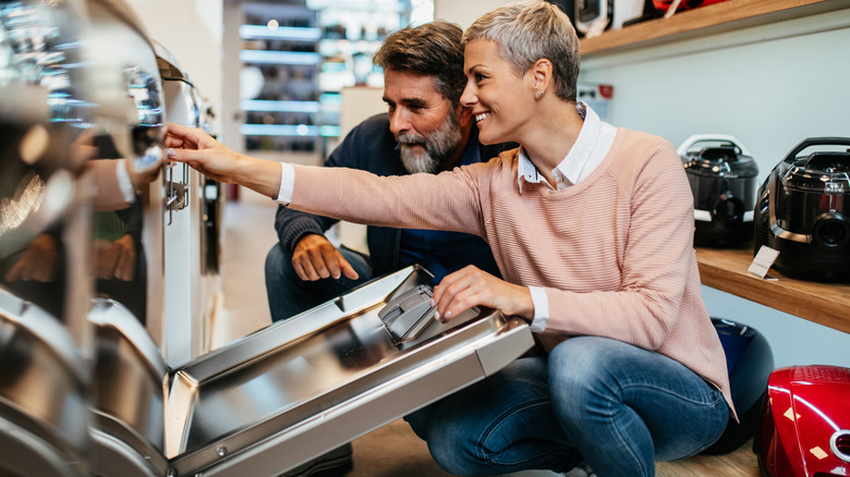 Couple purchasing a new dishwasher