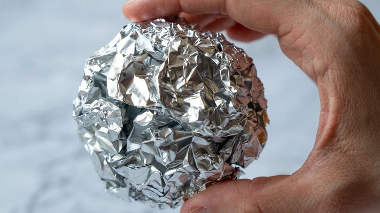 aluminum ball in person's hand