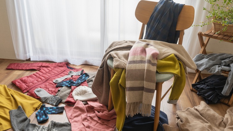 Clothes lying all over room