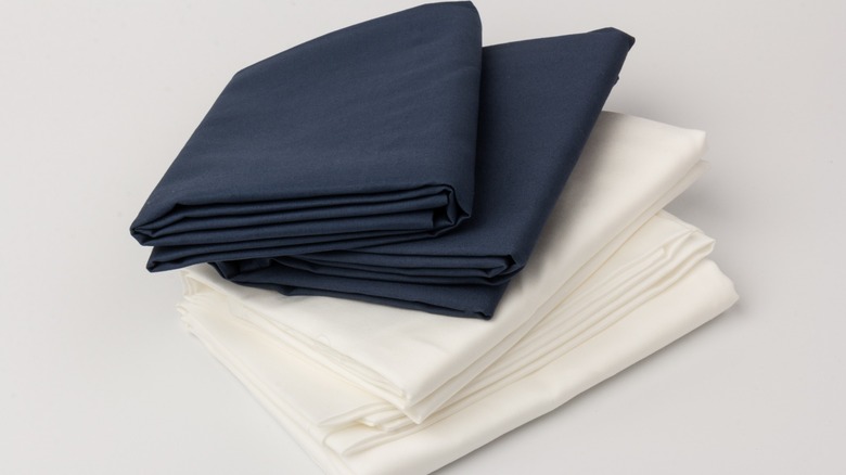 Folded white and navy pillowcases