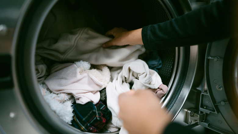 Person gets clean laundry out of the dryer