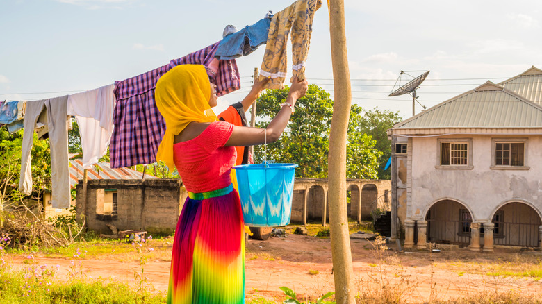 Woman hanging clothes in the sun