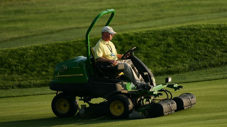 Person mowing with a John Deere commercial riding mower