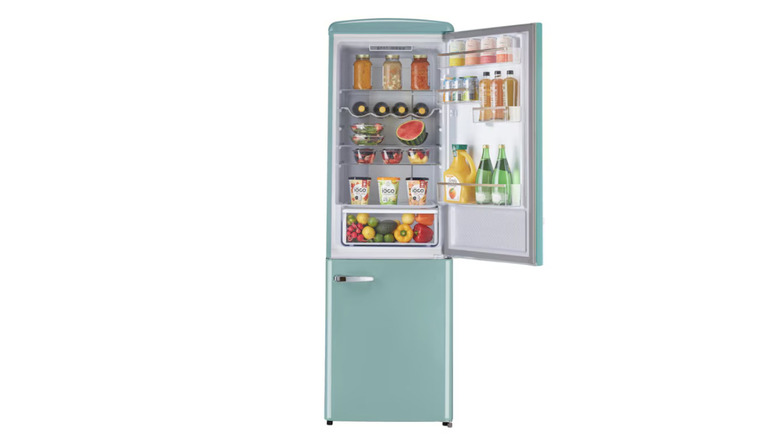 A green Unique brand retro refrigerator with open door