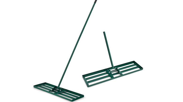 A green metal lawn leveling rake tool