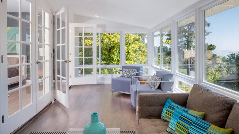 Bright sunroom furnished with chairs