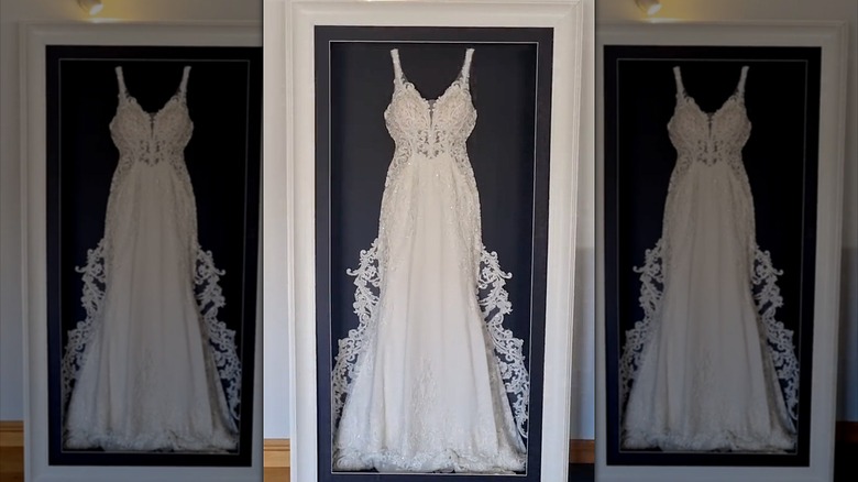 Wedding dress in large frame on wall