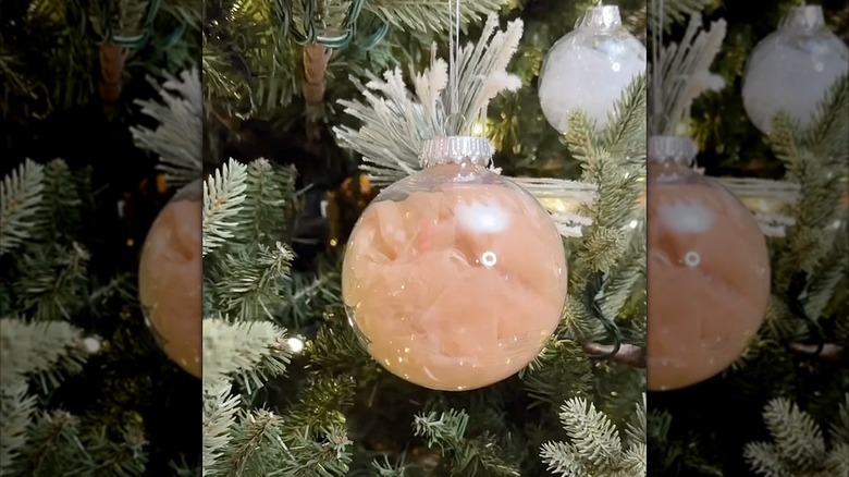 Clear ornament with lace on a tree