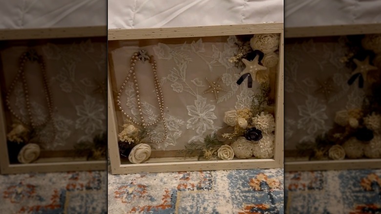 Wedding dress and keepsake items in shadow box