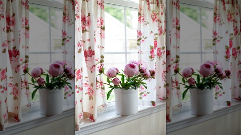 vintage floral cotton curtains behind bouquet of flowers