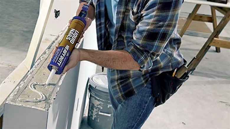 Applying Liquid Nails on PVC pipe