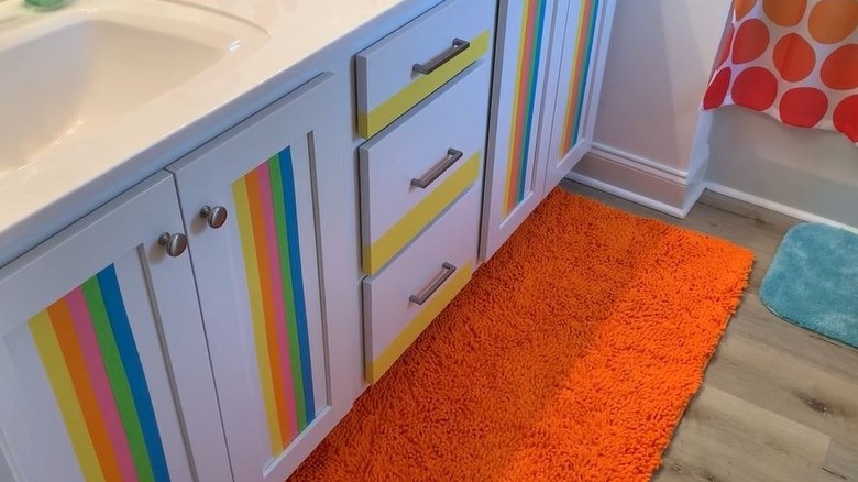 Rainbow washi tape applied to bathroom cabinet doors