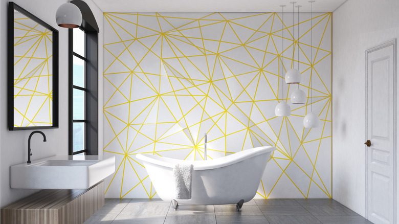 Modern bathroom with random geometric wall pattern, free-standing tub in center