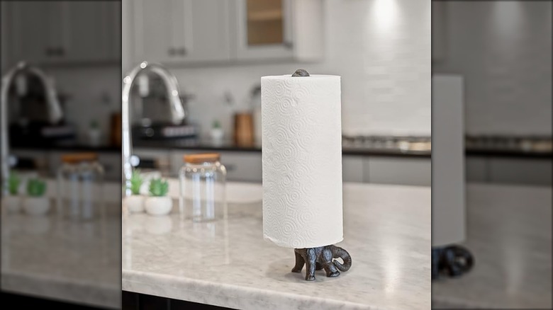 Dinosaur paper towel holder on a kitchen countertop