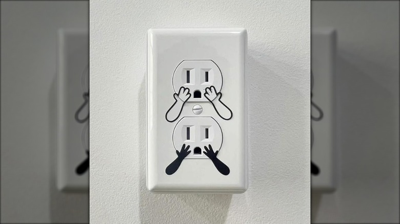 Electrical outlets with hand stickers on them