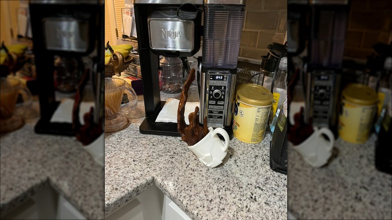 Coffee bar station with a statue of a coffee cup spilling