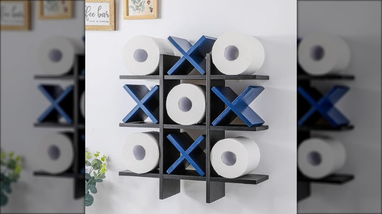 Toilet paper holder on a wall that resembles a big tic tac toe game