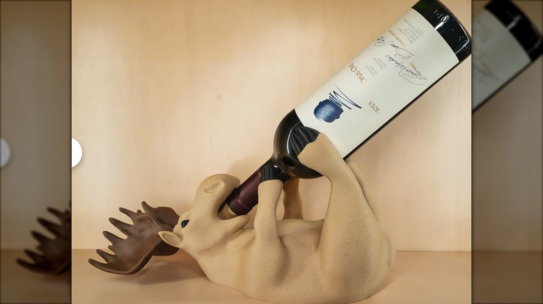 Moose bottle holder holding a wine bottle