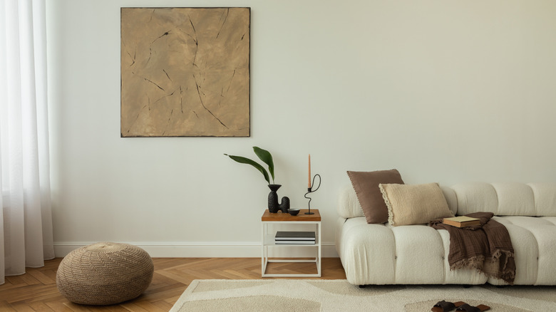 White sofa and abstract wall art in minimalist living room