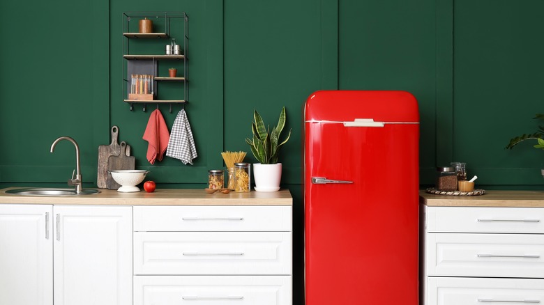 red fridge against green wall