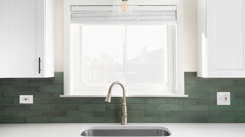 White kitchen with green backsplash