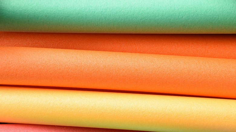 Green, orange, yellow pool noodles 