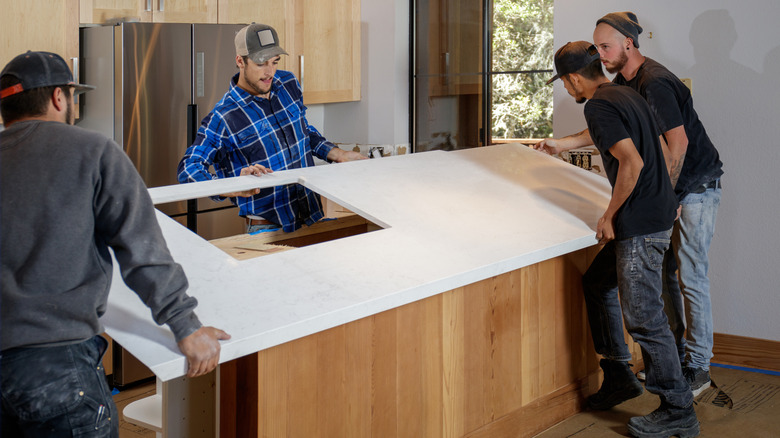 men installing a quartz countertop