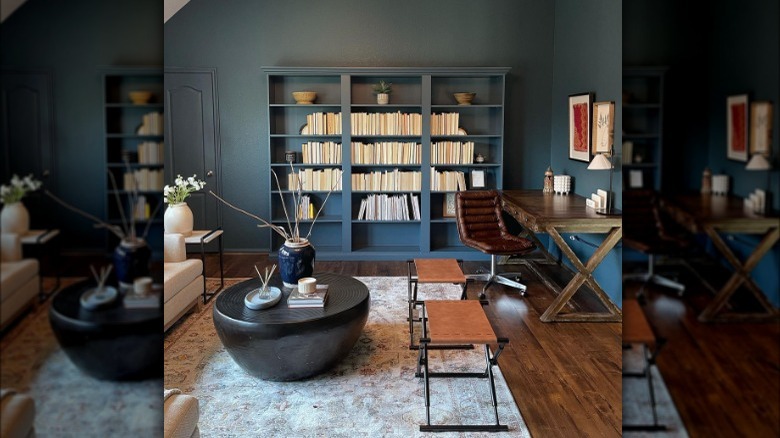 Room designed by Fariha Nasir with bookshelves, desk, and coffee table