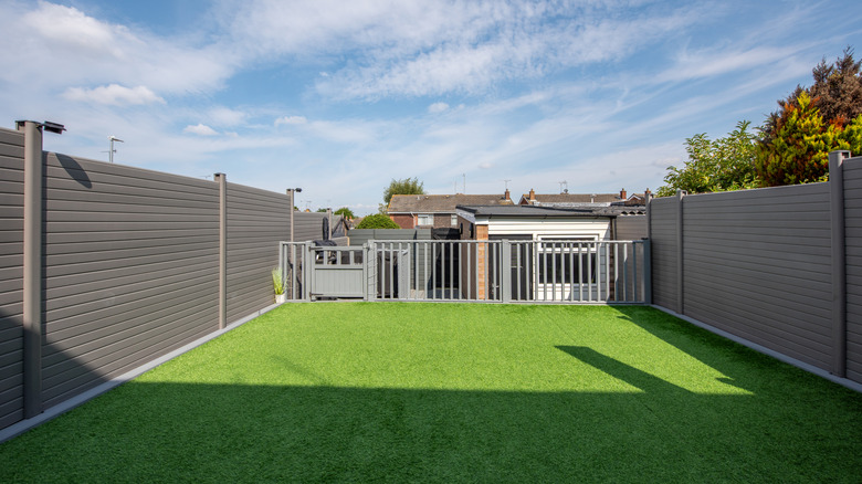 Gray composite backyard fence with high walls