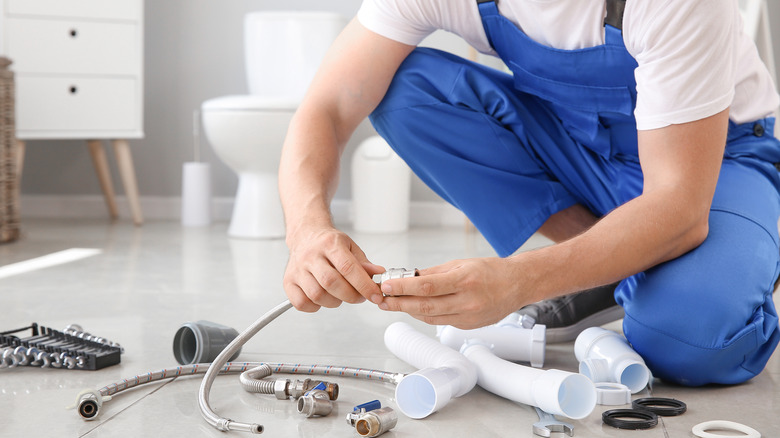 Plumber in bathroom