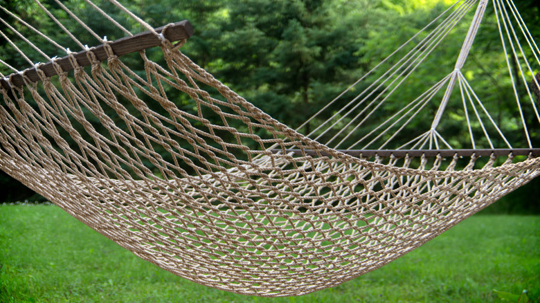 Woven hammock hanging in yard