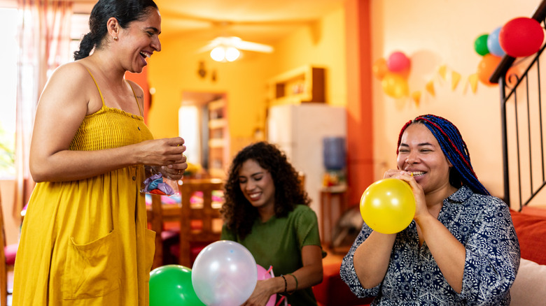 Family blowing up balloons together