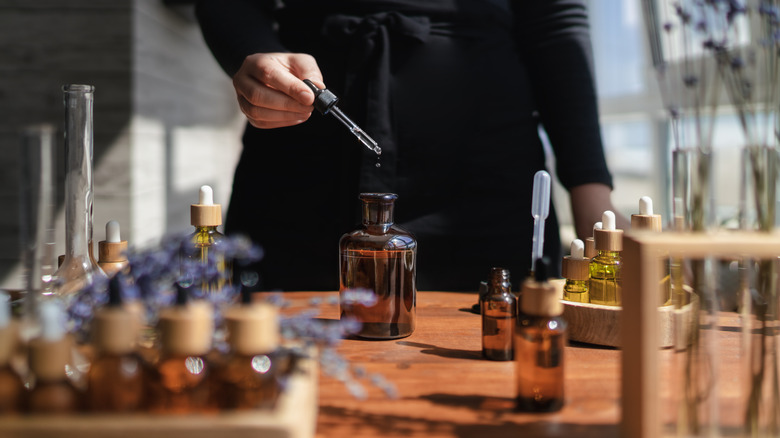 Person combining different essential oils