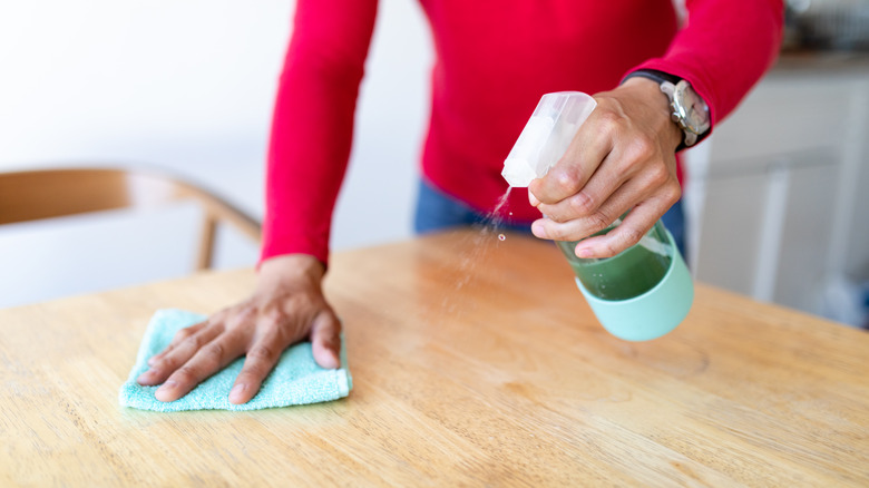 Person cleaning table